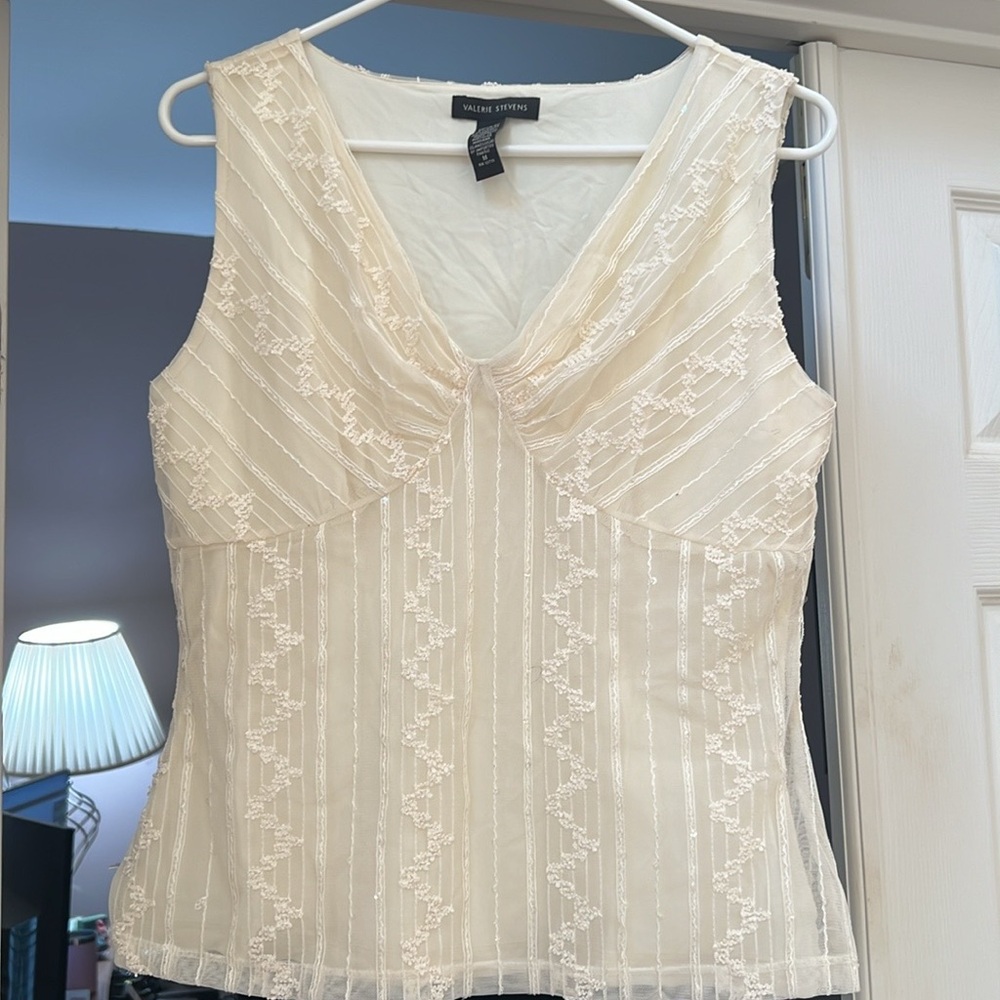 Valerie Steven’s sleeveless lace embellished top.